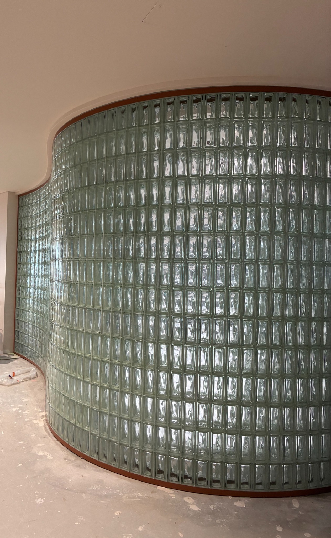 Large curved glass block wall with a shaped timber frame