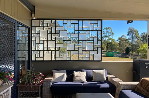 Custom decorative glass panel overlooking a garden