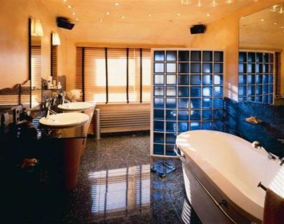 Distinctive bathroom featuring blue glass block walls