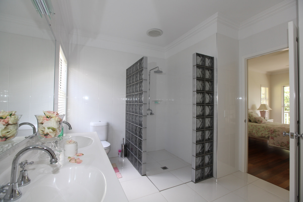 Glass block shower walls in a bright residential bathroom